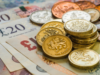 British pound coins and bank notes on table