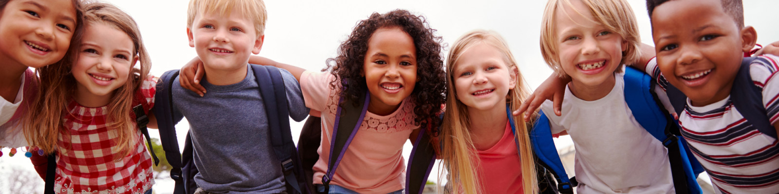 Group of happy children in school field